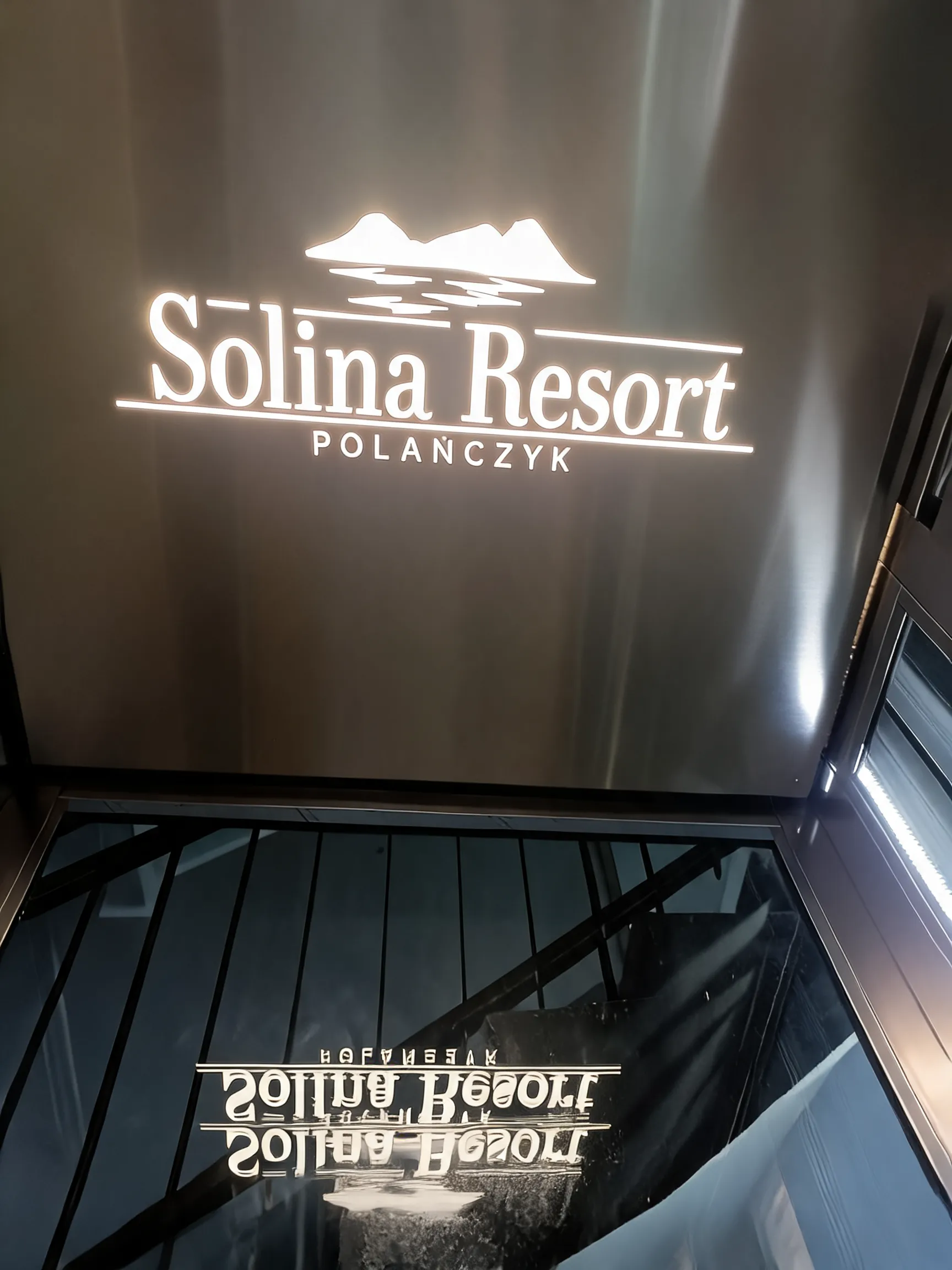 Podświetlane logo Solina Resort Polańczyk na ścianie kabiny